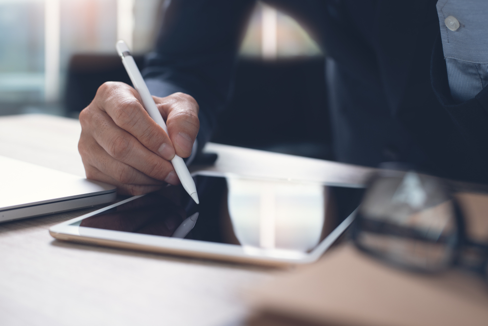 business person using tablet and stylus